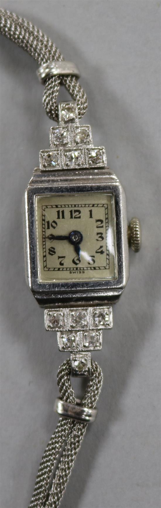 A ladys 1930s diamond and platinum manual wind cocktail watch, on a 9ct white gold twin strand bracelet.